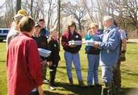 photo of many teaching a small group outdoors
